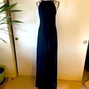 A shimmery strappy back holiday dress. It is black with blue shimmer worn once